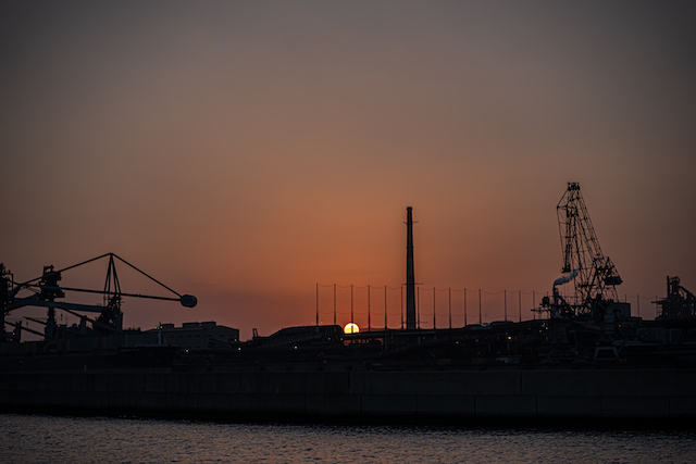 神戸製鋼の工場に沈んでいく太陽を撮影してみました。天気が良い日には真っ赤な太陽を見る事ができます。太陽が半分、工場に沈んで、オレンジ色の世界が広がっていく様子を撮影する事が出来ました。